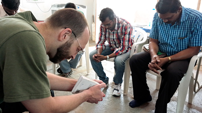 Christian men didn't cover during prayer. This photo was taken during prayer at the Compassion International Center.