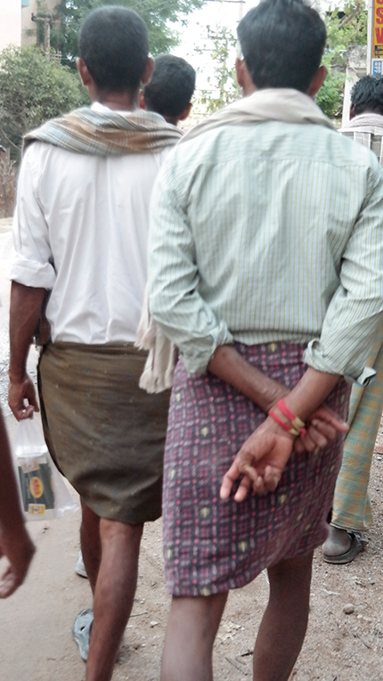 Men often donned head covers for protection from the hot summer sun in India.