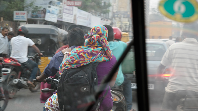 Head covering took on a practical application when coupled with the dense exhaust from vehicles driven by Hyderabad, India's 7+ million people.